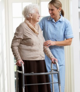 Carer Helping Elderly Senior Woman Using Walking Frame in Baltimore, MD area